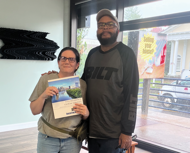 Woman and man holding book