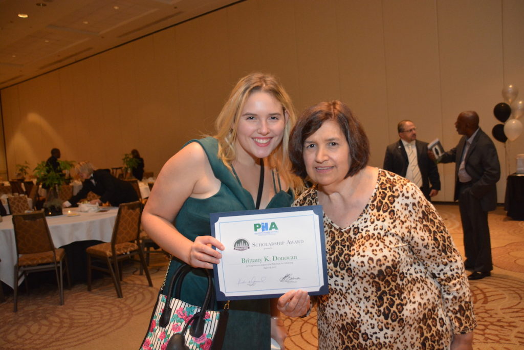 2 women holding award